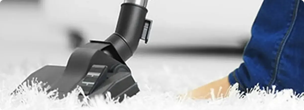 Close-up of a professional vacuuming a white carpet in Apollo Beach.